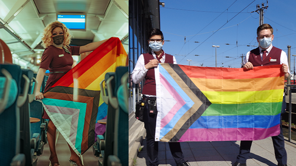 Mitarbeiter in Unternehmensbekleidung am Diversity Tag mit Regenbogenfahnen in den Händen