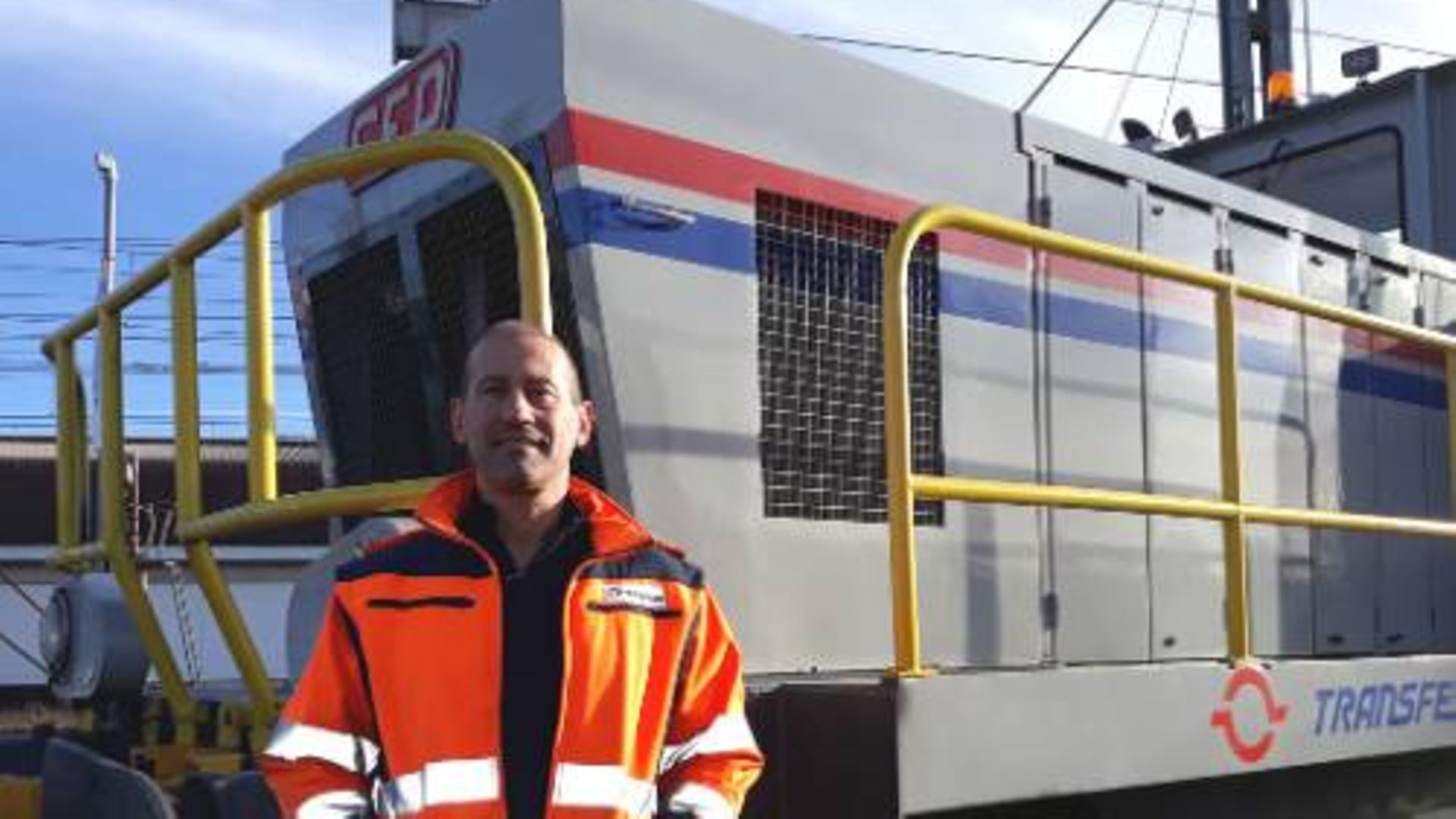 A train driver working for Transfesa Logistics standing in front of a train